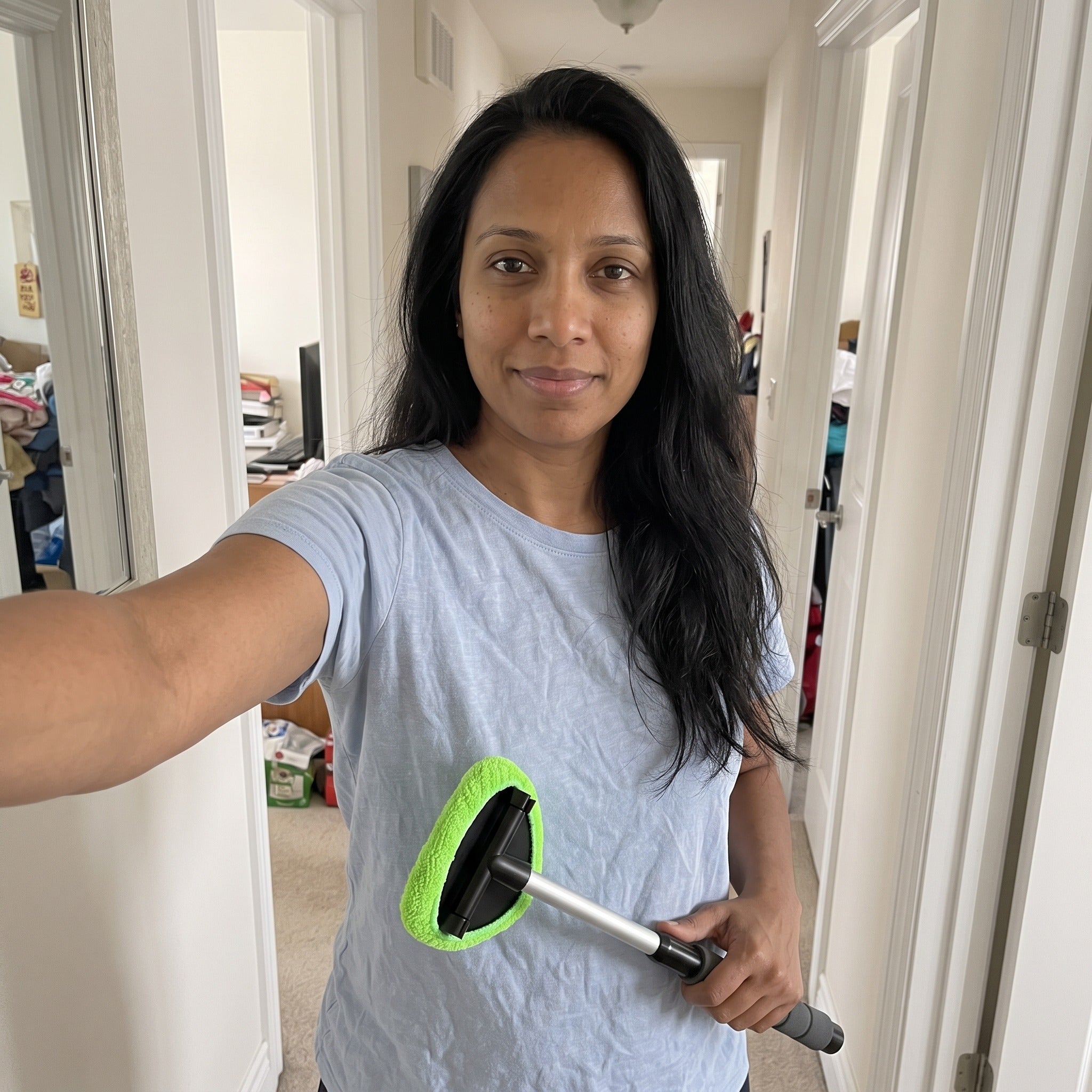 Selfie with cleaner beside a hallway mirror