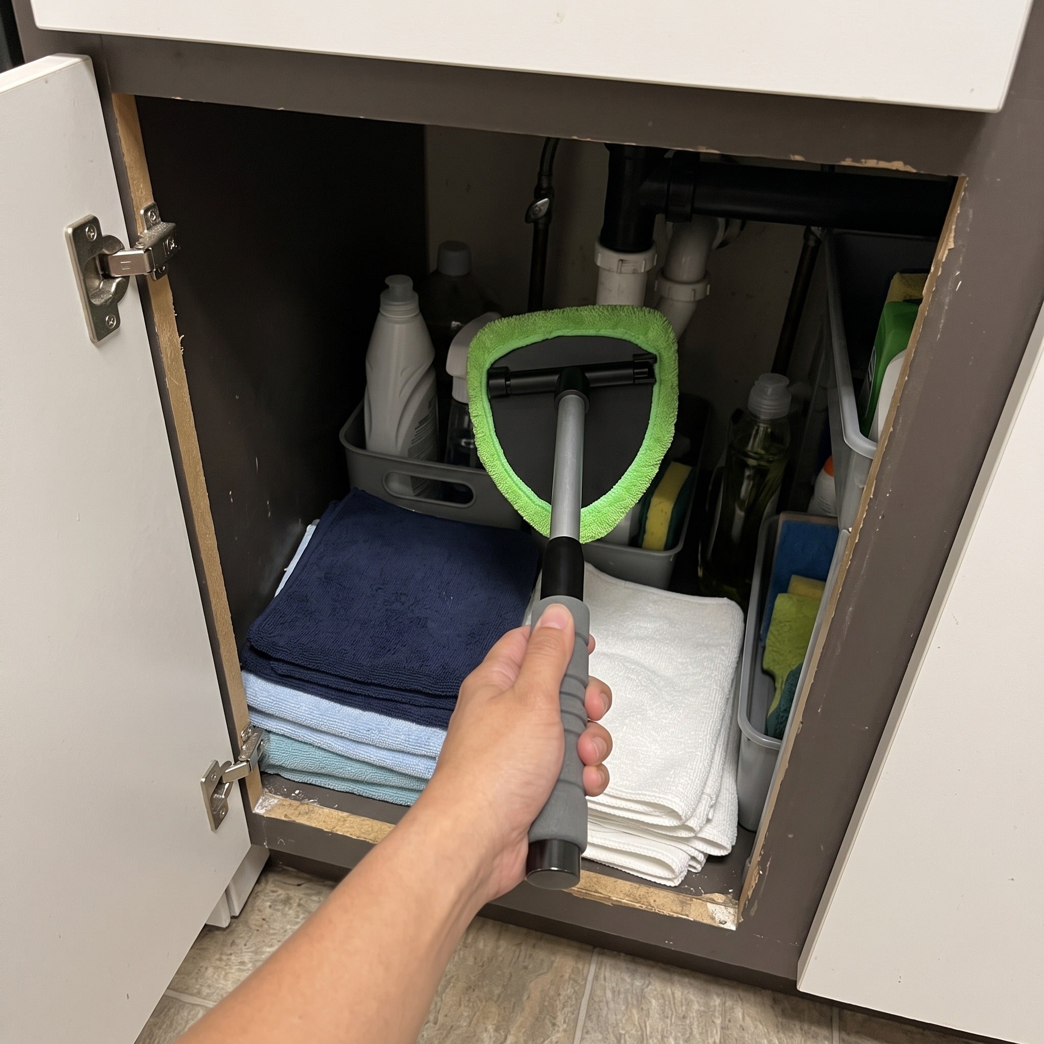 Cleaner stored in an under-sink cupboard