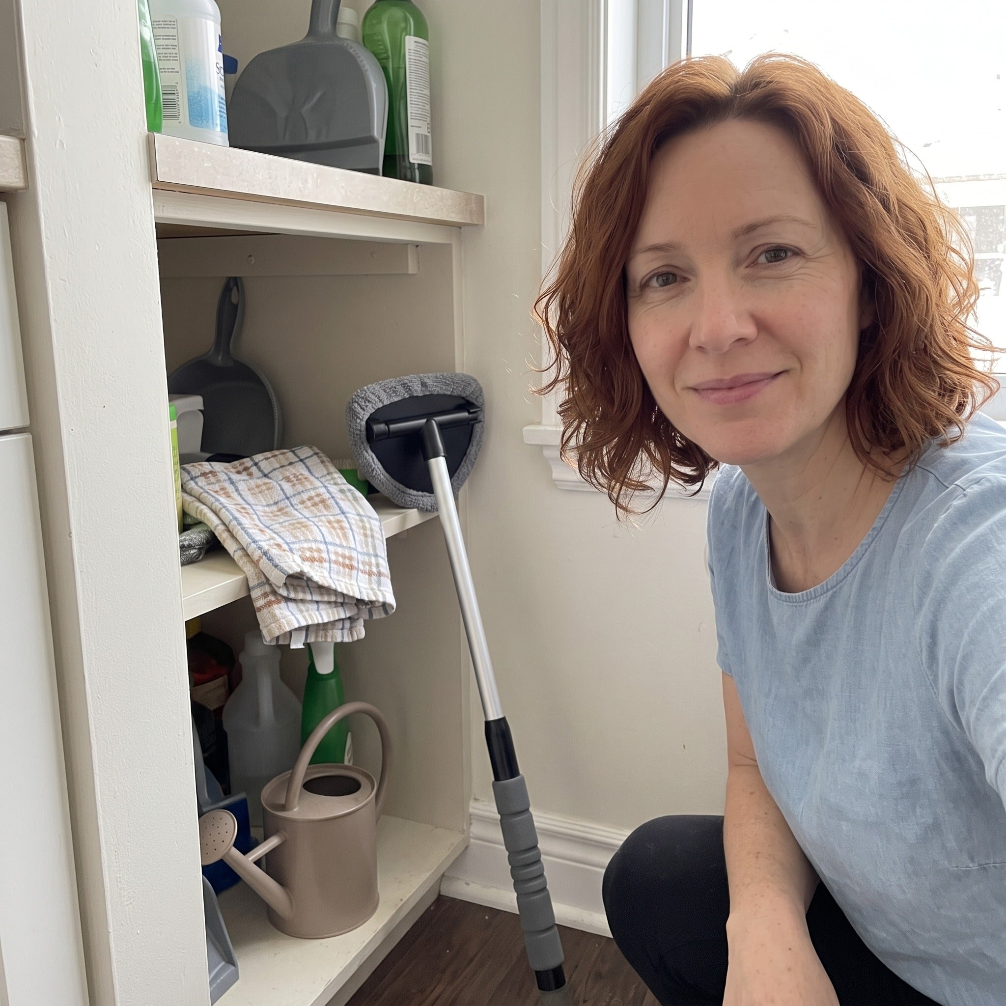 Sophie taking a selfie with the grey cleaner beside her utility cupboard