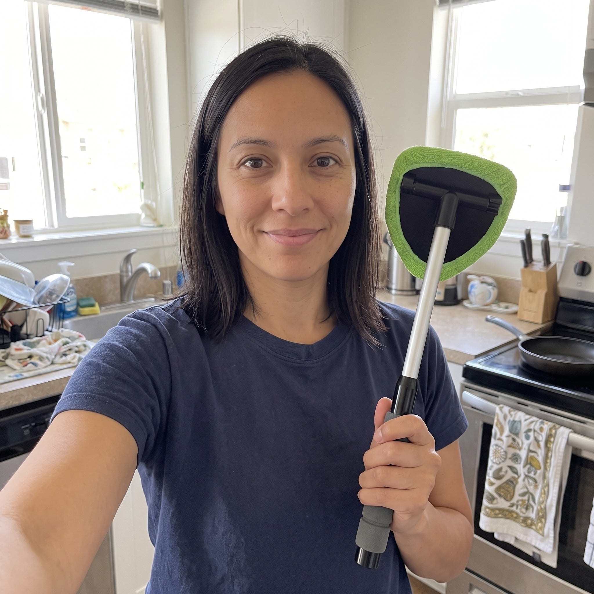 Maya taking a selfie with Clear Reach beside a kitchen window